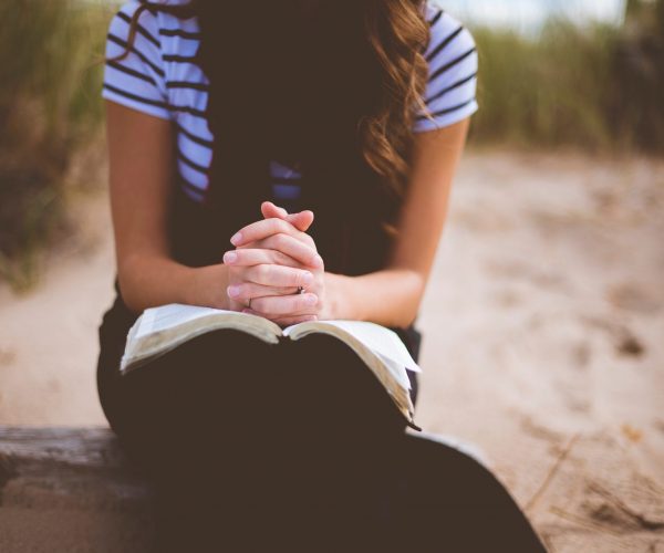 girl seated praying